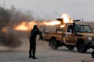 Imagine atasata: africa Libyan_rebel_fire_with_Type_63_107mm_multiple_rocket_launcher_system_mounted_on_light_pickup_truck_001.jpg